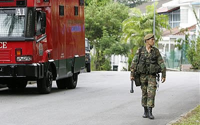 A national serviceman walks along a street. (AP Photo)