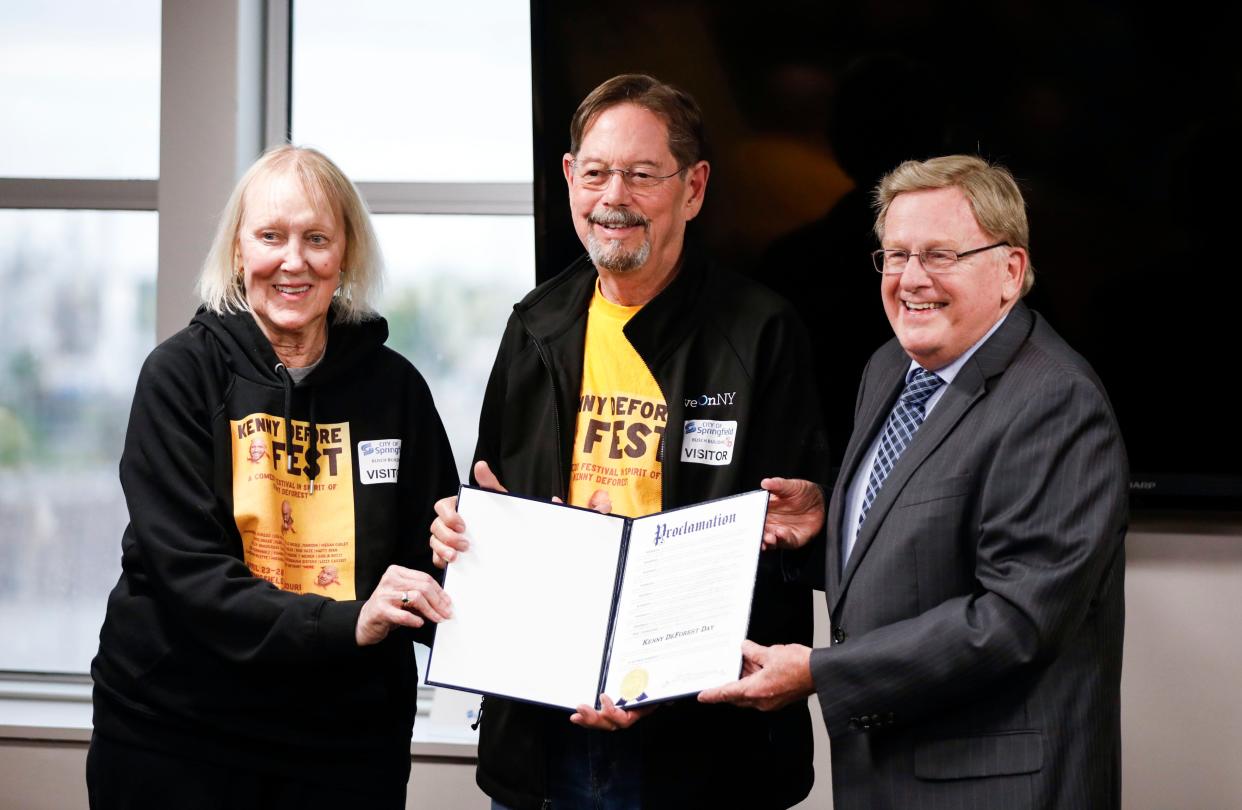 Springfield Mayor Ken McClure gives a proclamation naming April 23 Kenny DeForest Day, to DeForest's parents Roger and Pamela DeForest on Tuesday, April 23, 2024.