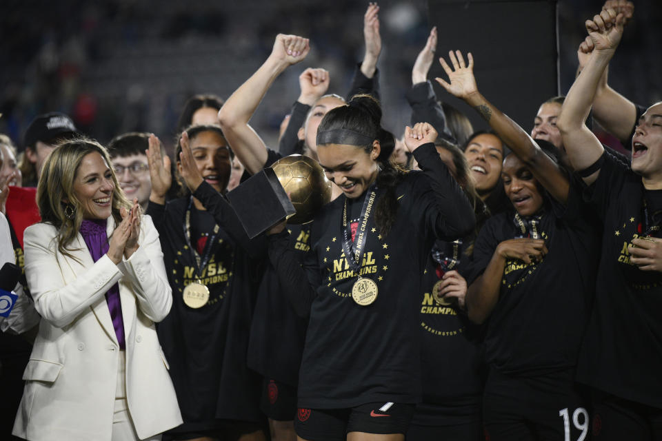 FILE - Portland Thorns forward Sophia Smith holds the MVP trophy after the team's NWSL championship soccer match against the Kansas City Current, Oct. 29, 2022, in Washington. At left is NWSL Commissioner Jessica Berman. Alyssa Thompson was the top pick in the NWSL draft by Angel City on Thursday, Jan. 12, becoming the first high school player to be selected in the history of the league. In the hours before the draft, Berman spoke to reporters at length about the state of the 12-team league. (AP Photo/Nick Wass, File)