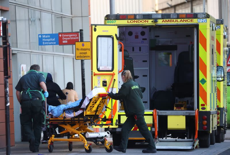 Paramedics transfer a patient outside the Royal London Hospital , amid the coronavirus disease (COVID-19) outbreak, in London