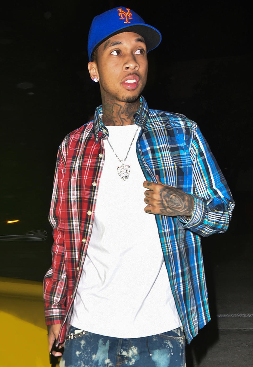 <p>What's a young rap wunderkind to do when he wants to wear both of his lucky plaid shirts at the same time but doesn't want to ruin his silhouette? Follow in Tyga's footsteps and simply cut them down the middle, sew them back together, and pair with bleach-splattered denim for good measure.</p>