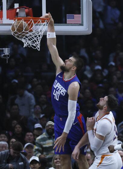 Clippers center Ivica Zubac dunks in front of Phoenix Suns center Jusuf Nurkic at Crypto.com Arena.