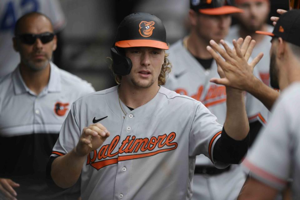 Baltimore Orioles' Gunner Henderson celebrates in the dugout with teammates after scoring on a fielder's choice in the 10th inning of a baseball game against the Chicago White Sox, Saturday, April 15, 2023, in Chicago. Chicago won 7-6 in 10 innings. (AP Photo/Paul Beaty)