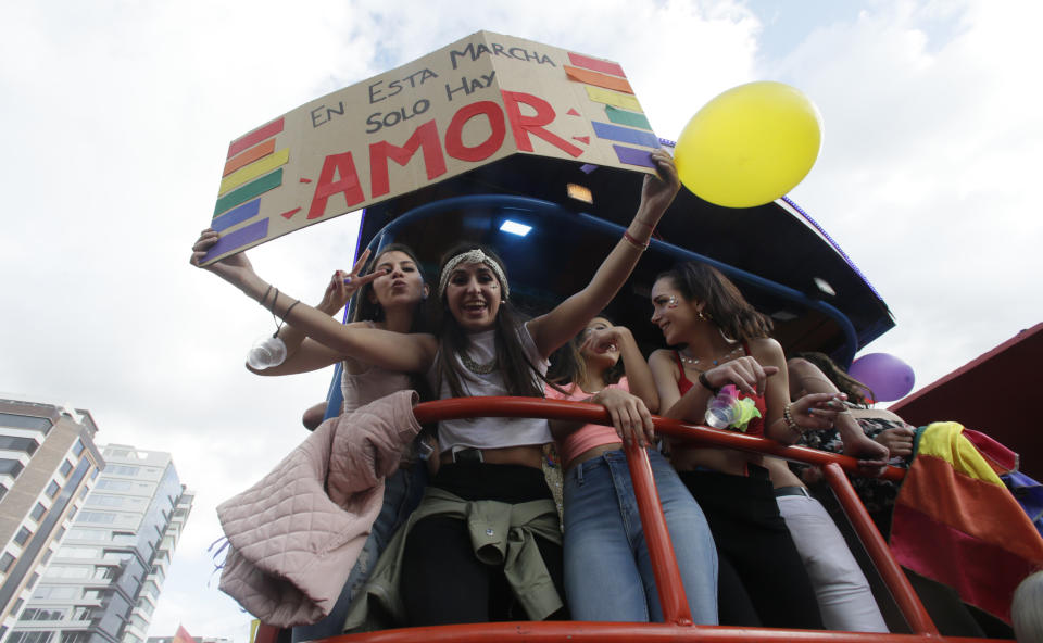 Revelers hold a sign that reads ins Spanish "In this parade there is only love" as they attend the Gay Pride Parade in Quito, Ecuador, Saturday, June 29, 2019. (AP Photo/Dolores Ochoa)