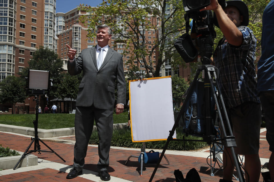 Attorney Kevin Downing, left, gestures to the rest of the defense team for Paul Manafort, as the team leaves federal court for a lunch break during the trial of the former Trump campaign chairman, in Alexandria, Va., Thursday, Aug. 9, 2018. (AP Photo/Jacquelyn Martin)