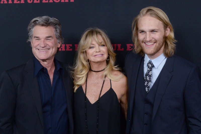 Wyatt Russell (R), pictured with Kurt Russell (L) and Goldie Hawn, stars in the supernatural horror film "Night Swim." File Photo by Jim Ruymen/UPI