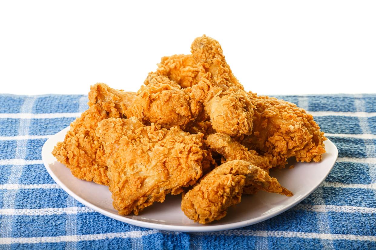 Fresh, fried chicken on a square white plate