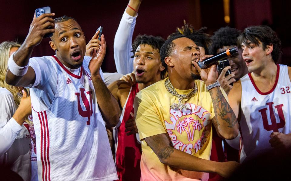 Tamar Bates, left, CJ Gunn, center, and Will Galloway, right, sing on stage as G Herbo performs during Hoosier Hysteria for the basketball programs at Simon Skjodt Assembly Hall on Friday, Oct. 7, 2022.
