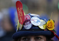 An anti-Brexit demonstrator wears a hat adorned with anti Brexit statements as she protests outside the Palace of Westminster in London, Thursday, Feb. 14, 2019. British lawmakers are holding another series of votes on Brexit legislation Thursday. (AP Photo/Alastair Grant)