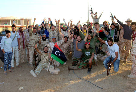 Fighters of Libyan forces allied with the U.N.-backed government celebrate as they are close to securing last Islamic State holdouts in Sirte, Libya December 5, 2016. Picture taken December 5, 2016. REUTERS/Ayman Sahely