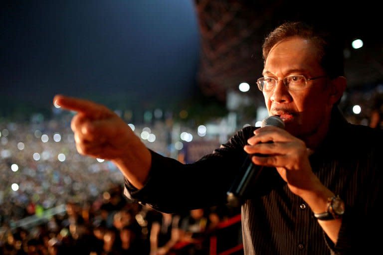 Malaysian opposition leader Anwar Ibrahim speaks during a rally at a stadium in Kelana Jaya, Selangor on May 8, 2013. Anwar late Wednesday addressed a rally of supporters dressed in black, to protest Sunday's polls, who filled a stadium and spilled out into surrounding areas, swamping a corner of the capital Kuala Lumpur in hours-long gridlock