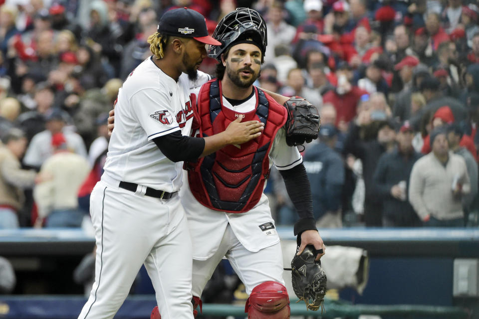 Cleveland Guardians relief pitcher Emmanuel Clase, left, celebrates with catcher Austin Hedges, right, after the Guardians defeated the Tampa Bay Rays in a wild card baseball playoff game, Friday, Oct. 7, 2022, in Cleveland. (AP Photo/Phil Long)