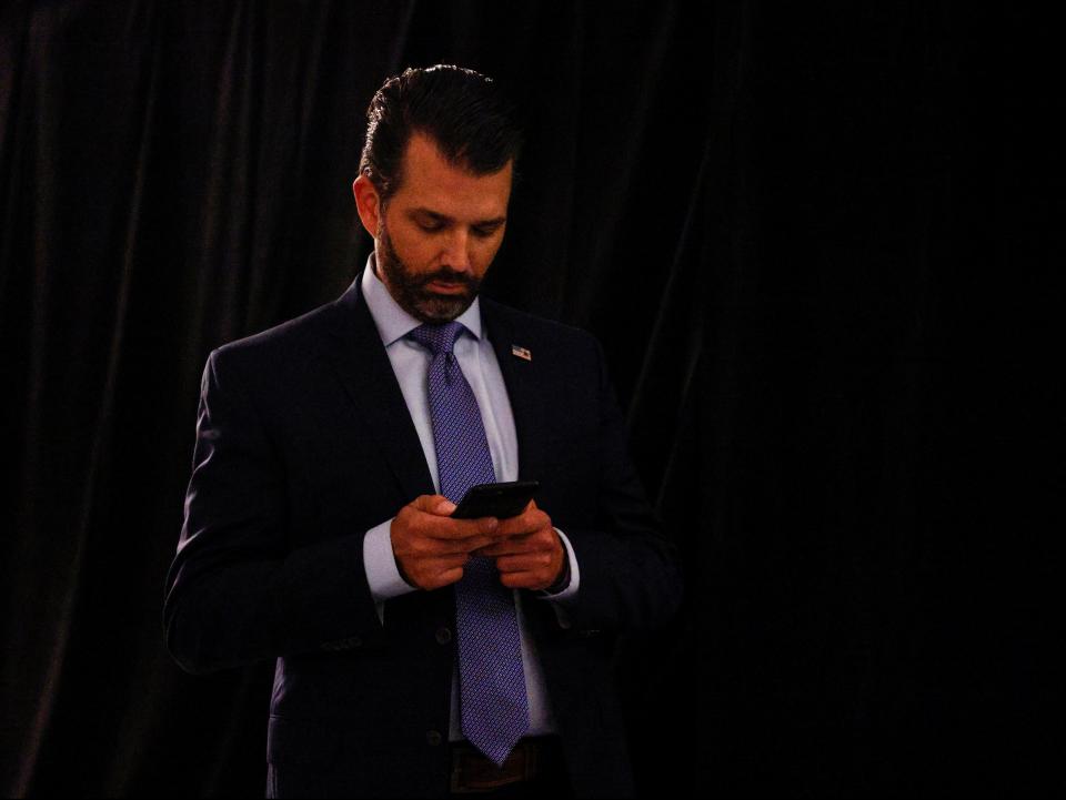 Donald Trump Jr uses his phone as he leaves after the first 2020 presidential campaign debate (REUTERS)