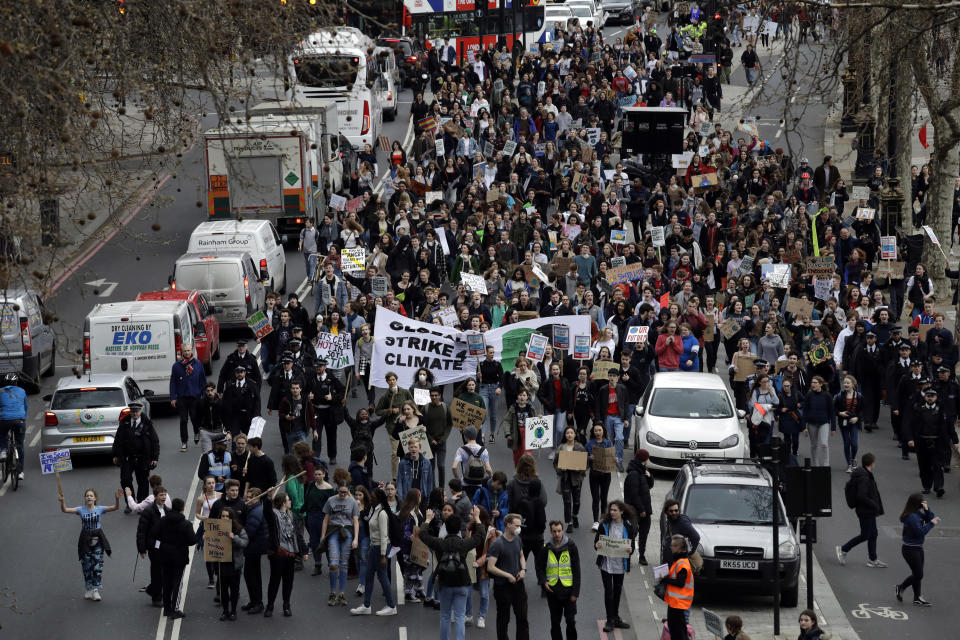 Youngsters march through traffic as they take part in a student climate protest in London, Friday, March 15, 2019. Students in more than 80 countries and territories worldwide plan to skip class Friday in protest over their governments' failure to act against global warming. The coordinated 'school strike' was inspired by 16-year-old activist Greta Thunberg, who began holding solitary demonstrations outside the Swedish parliament last year. (AP Photo/Matt Dunham)