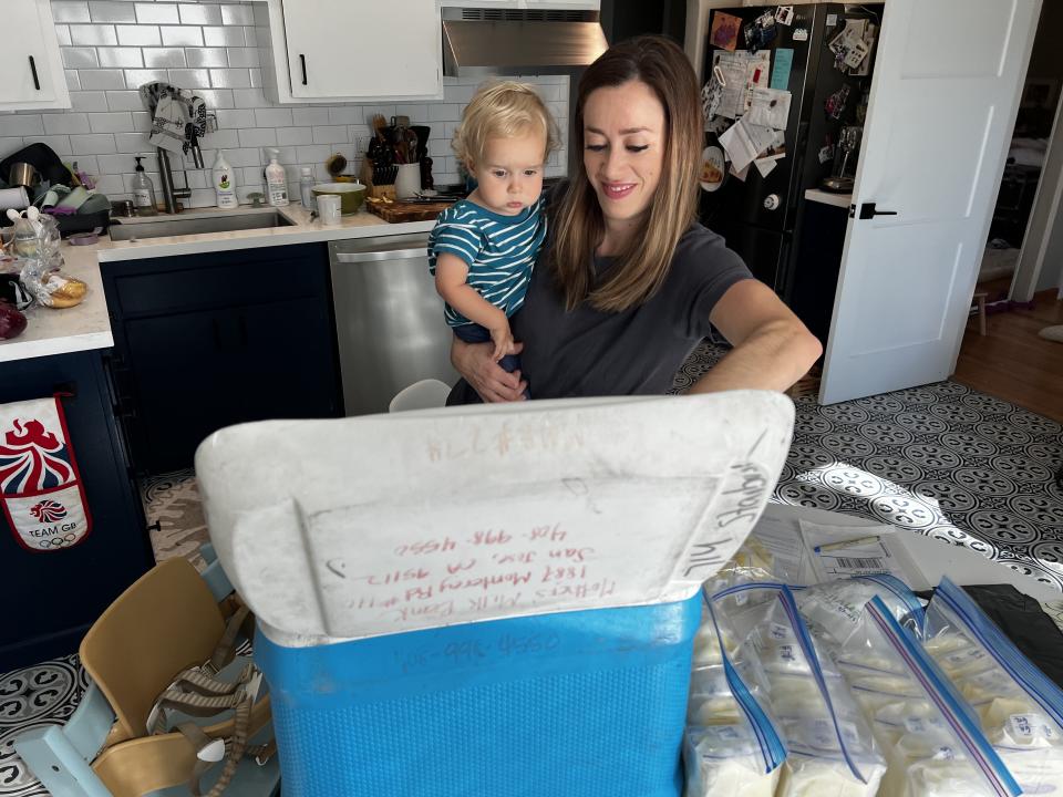 Chiara Sottile showing her 13-month-old son the cooler full of her donated breast milk headed for the milk bank.