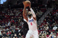 Los Angeles Clippers forward Marcus Morris Sr., right, shoots in front of Portland Trail Blazers forward Tony Snell during the first half of an NBA basketball game in Portland, Ore., Monday, Dec. 6, 2021. (AP Photo/Craig Mitchelldyer)