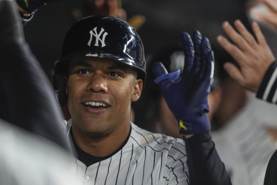 New York Yankees' Juan Soto celebrates with teammates after hitting a three-run home run during the seventh inning of a baseball game against the Tampa Bay Rays, Friday, April 19, 2024, in New York. (AP Photo/Frank Franklin II)