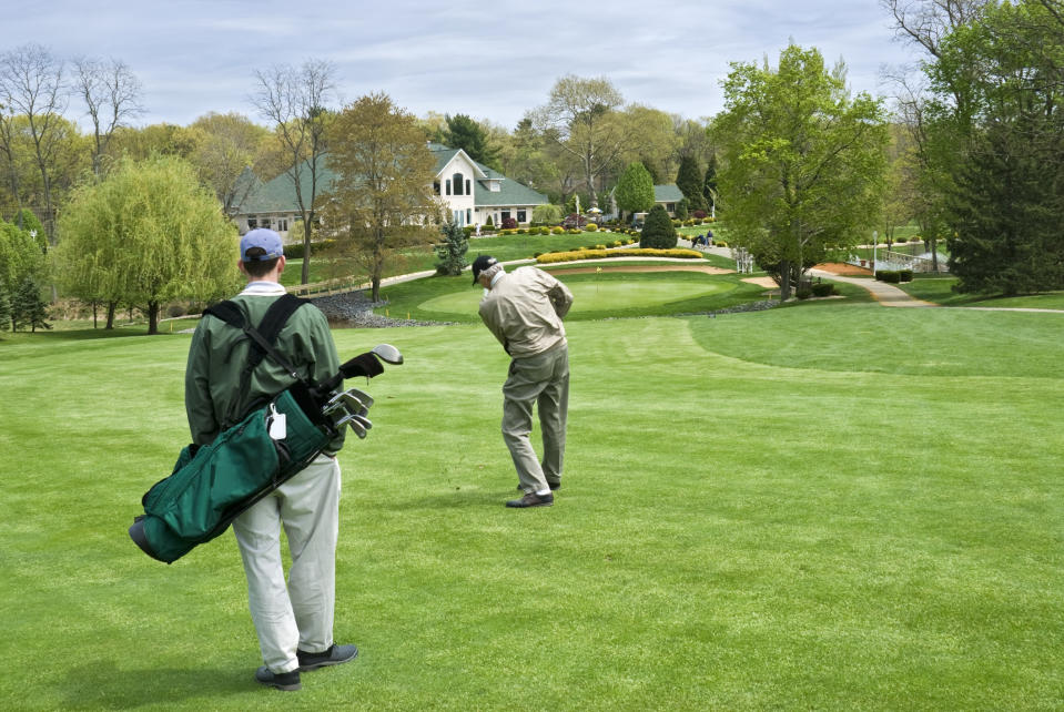 two people on a golf course