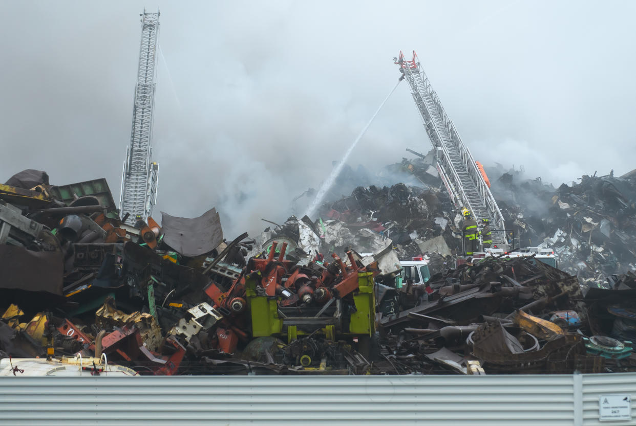 Firefighters battle a blaze on Thursday, Sept. 14, 2023, at a metal recycling yard along the harbour at Saint John, New Brunswick, that has led to the closure of three schools in the area. THE CANADIAN PRESS/Michael Hawkins