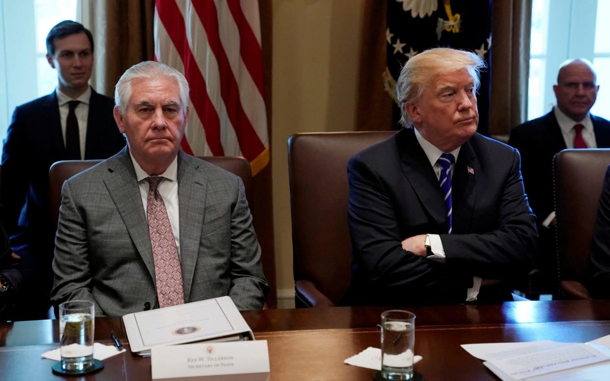 Donald Trump and Rex Tillerson look up during a Cabinet meeting at the White House last week - REUTERS