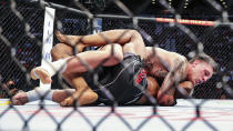 Brendan Allen, top, looks for a submission hold on Karl Roberson during a UFC 261 mixed martial arts bout, Saturday, April 24, 2021, in Jacksonville, Fla. It is the first UFC event since the onset of the COVID-19 pandemic to feature a full crowd in attendance. (AP Photo/Gary McCullough)