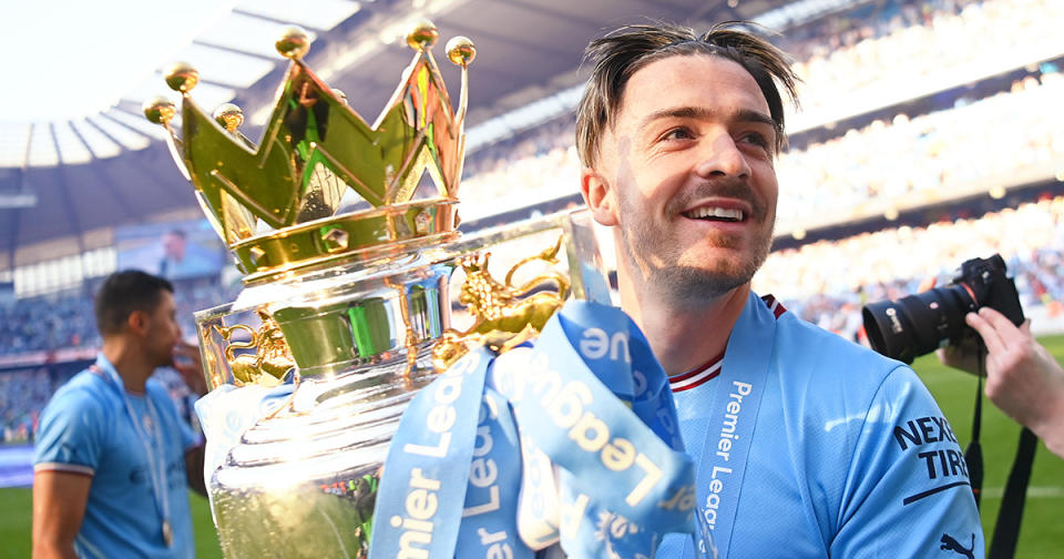 Jack Grealish of Manchester City celebrates with the Premier League trophy following the Premier League match between Manchester City and Chelsea FC at Etihad Stadium on May 21, 2023 in Manchester, England.