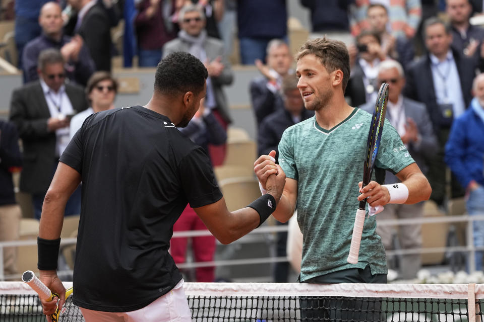 Norway's Casper Ruud, right, shakes hands with France's Jo-Wilfried Tsonga after their first round match of the French Open tennis tournament at the Roland Garros stadium Tuesday, May 24, 2022 in Paris. The Frenchman retired following his first-round loss against Casper Ruud. (AP Photo/Michel Euler)