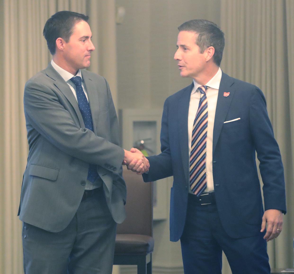 Secretary of State Frank LaRose and businessman Bernie Moreno shake hands after a Republican U.S. Senate forum in Akron in October.