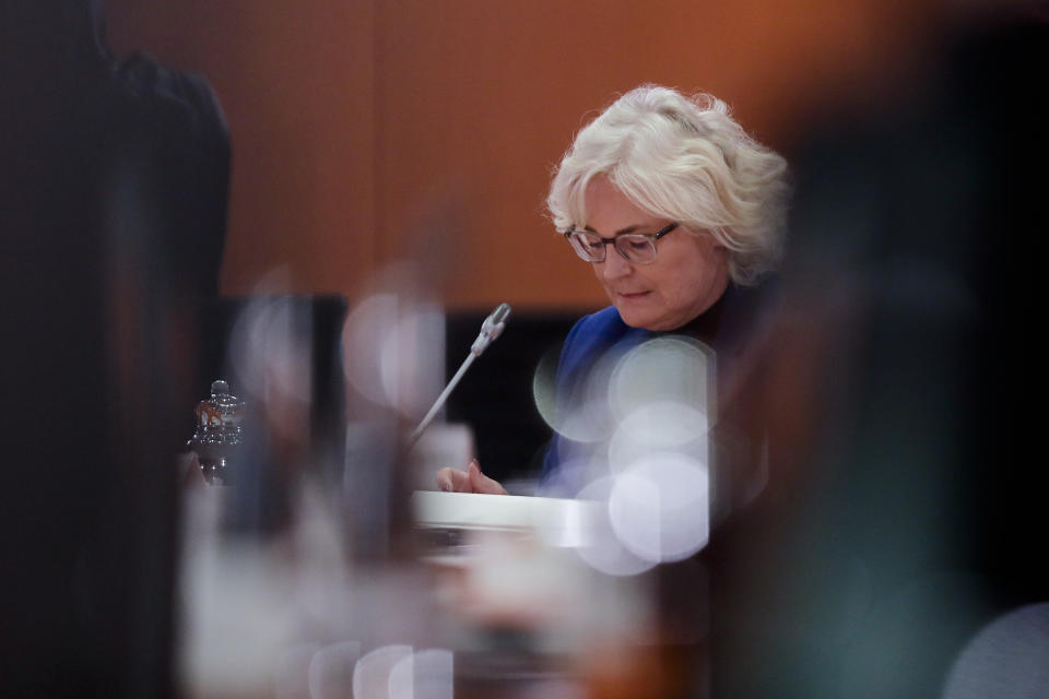 German Justice Minister Christine Lambrecht reads in her documents prior to the weekly cabinet meeting of the German government at the chancellery in Berlin, Wednesday, Oct. 21, 2020. (AP Photo/Markus Schreiber, Pool)