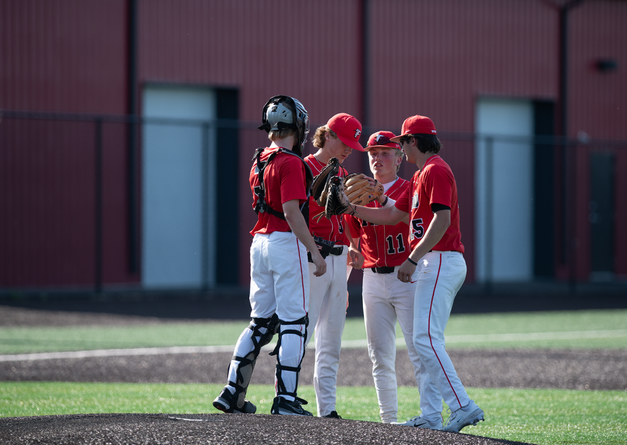 Carter Little, Caleb Gartner, Braxton Baumberger and Grady Eader huddle on the mound in last year's regional semifinal. Baumberger and Gartner will be hard to replace but Eader and Little are poised to help lift Field to a strong 2024.