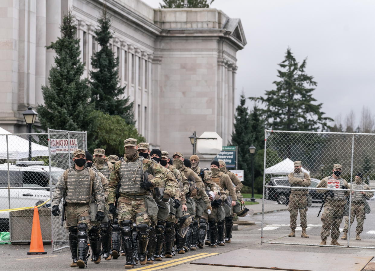 <p>Members of the National Guard leave the perimeter of the Washington State Capitol while providing extra security in Olympia, Washington, USA, 17 January 2021. </p> (EPA)