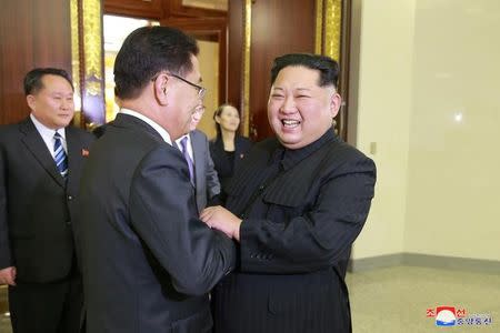 North Korean leader Kim Jong Un greets a member of the special delegation of South Korea's President at a dinner in this photo released by North Korea's Korean Central News Agency (KCNA) on March 6, 2018. KCNA/via Reuters
