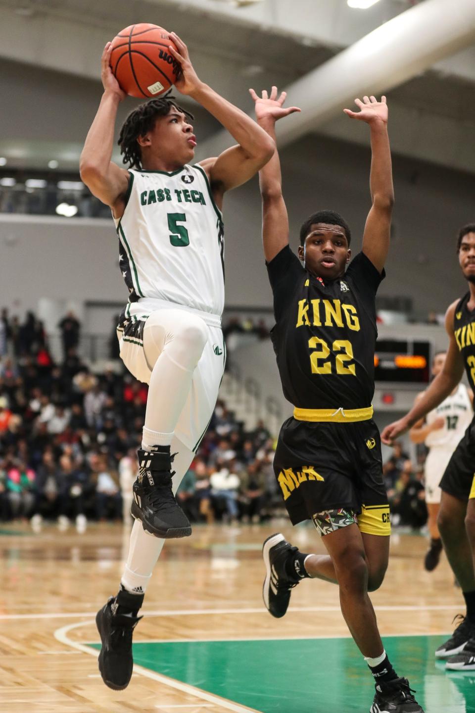 Cass Tech's Darius Acuff (5) goes to the basket against  Detroit King's Daniel Hayes (22) during the first half at the Wayne State Fieldhouse in Detroit on Sunday, February 19, 2023.