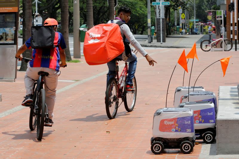 FILE PHOTO: Rappi delivery workers observe delivery robots from the Colombian company Rappi in Medellin