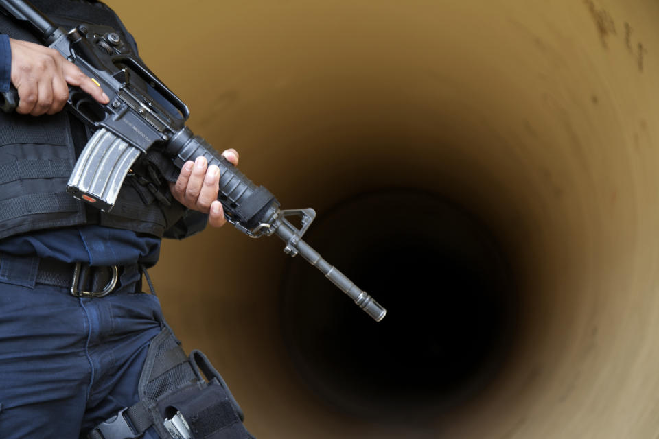 A federal police inspects a drainage pipe outside the Altiplano maximum security prison in Almoloya, west of Mexico City, Sunday, July 12, 2015. (AP Photo/Marco Ugarte)