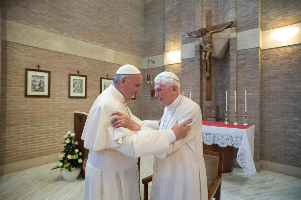 FILE - Pope Francis, left, embraces Pope Emeritus Benedict XVI, at the Vatican, on June 28, 2017. In an interview with The Associated Press Tuesday, Jan. 24, 2023, Pope Francis said he hasn't even considered issuing norms to regulate future papal resignations and says he plans to continue on for as long as he can as bishop of Rome, despite a wave of attacks against him by some top-ranked cardinals and bishops.(L'Osservatore Romano/Pool Photo via AP, File)