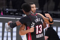 Miami Heat's Bam Adebayo (13) hugs Boston Celtics' Jayson Tatum, right, after the Heat's win over the Celtics in a NBA conference final playoff basketball game Sunday, Sept. 27, 2020, in Lake Buena Vista, Fla. (AP Photo/Mark J. Terrill)