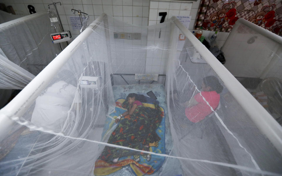 In this photo taken on Aug. 20, 2019, a patient receives treatment for dengue inside a room at the University School Hospital in Tegucigalpa, Honduras. At least 135 people have died from dengue this year in Honduras, nearly two-thirds of them children. (AP Photo/Eduardo Verdugo)