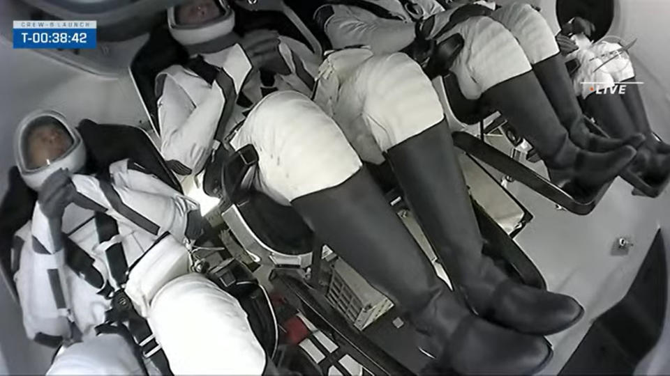 The Crew-6 astronauts on SpaceX's Crew Dragon Endeavour with their spacesuit visors down.