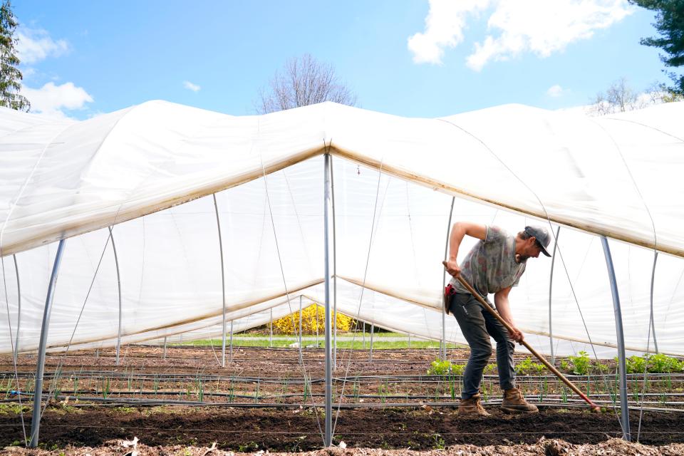 A.J. Albanos, who manages propagation and general field operations at the Closter Farm, prepares the soil for planting on Tuesday, April 12, 2022.