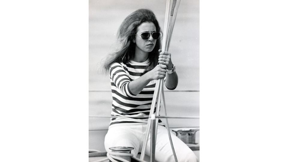 The Princess royal wears a striped tshirt and sunglasses as she wears her hair down while on a yacht