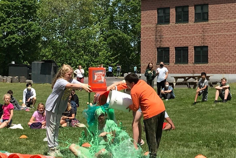 Breleigh Vischer (6th grade), Maeve Schreck (6th grade), and Thomas Shupe (7th grade) slimed Mr. Weld on May 26, 2022.