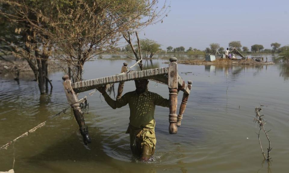 Villagers retrieve belongings, which were kept on higher ground, at a village in Sohbat Pur, a flood-hit district of Baluchistan province, Pakistan