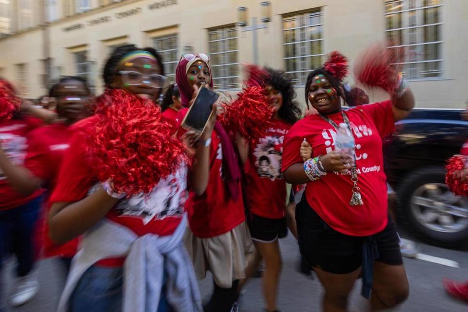 Thousands of women and members of the Girls Inc. of Tarrant County walk past the Federal Courthouse on West 10th Street for the 2023 Day of the Girl march at Burnett Park in Fort Worth on Friday.