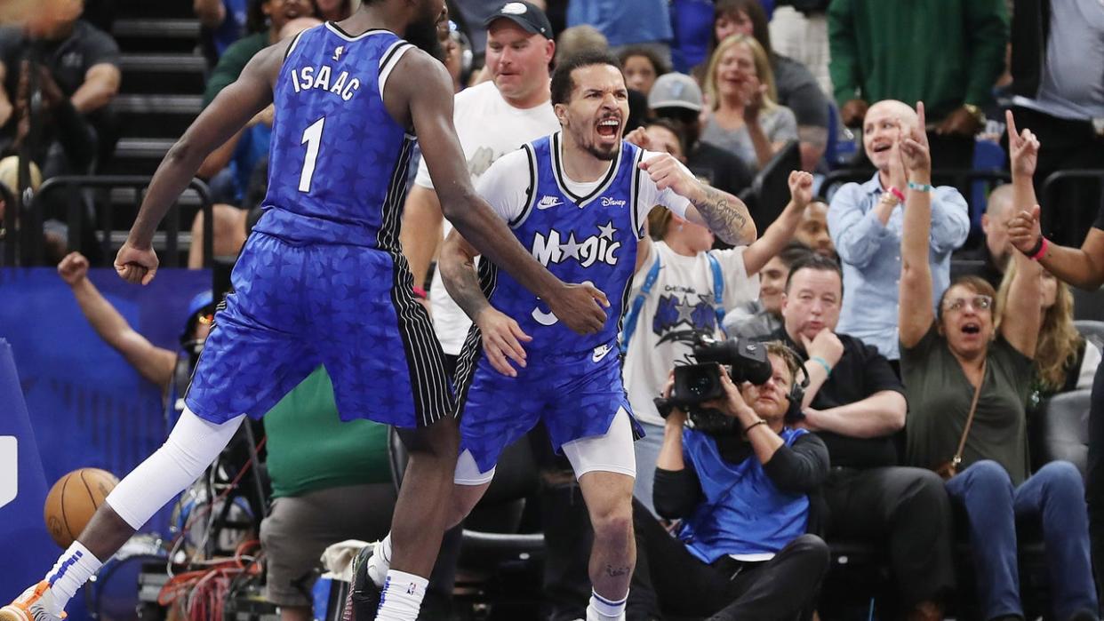 <div>Orlando Magic guard Cole Anthony (50) and center Jonathan Isaac celebrate late in the game against the Milwaukee Bucks at the Kia Center on Sunday, April 14, 2024, in Orlando, Florida. Orlando won the game 113-88 to clinch a playoff berth. (Stephen M. Dowell/Orlando Sentinel/Tribune News Service via Getty Images)</div>