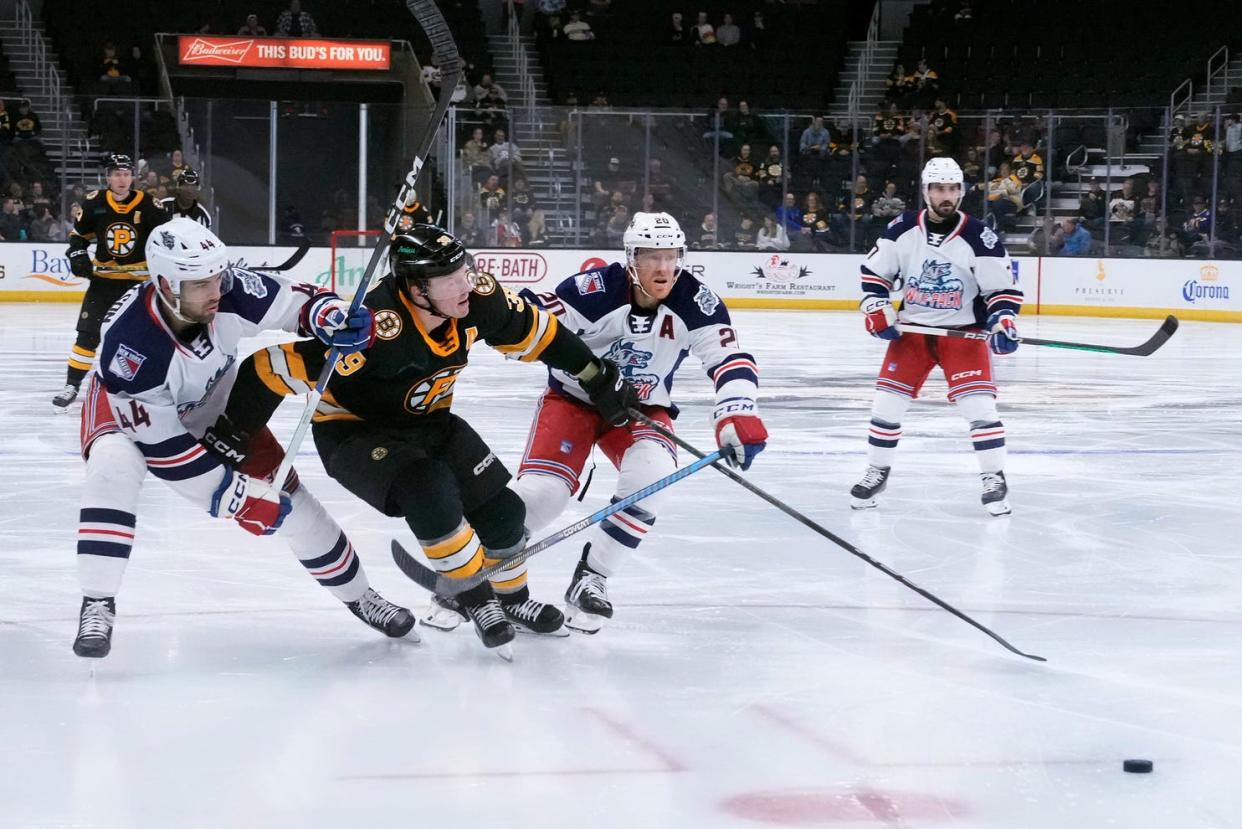 Hartford defenders Matthew Robertson and Riley Nash squeeze out incoming PBruin center Patrick Brown during second period Calder Cup action at the AMP.