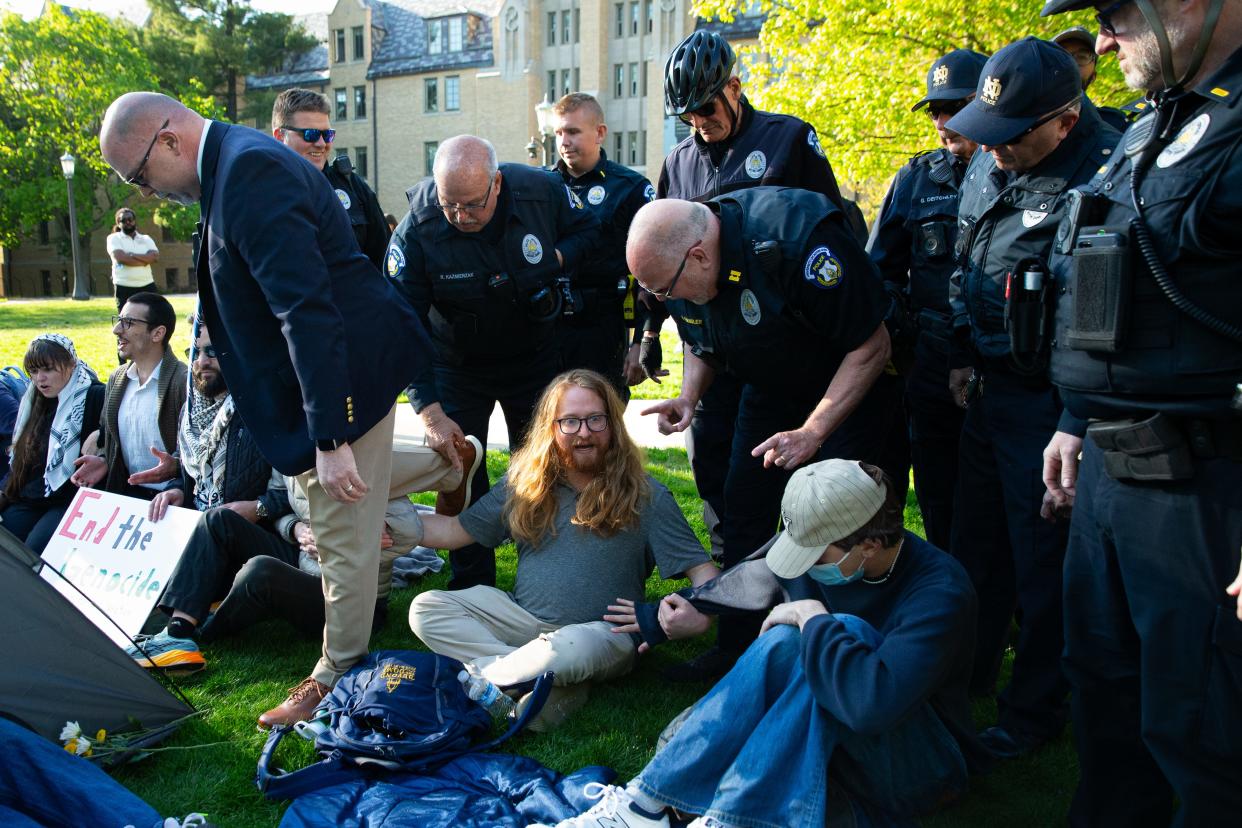 A protestor who self-described as a South Bend and Jewish community member, center, refuses Notre Dame police's request to leave during a pro-Palestinian protest on Notre Dame's campus on Thursday, April 25, 2024.
(Credit: MICHAEL CLUBB/SOUTH BEND TRIBUNE)
