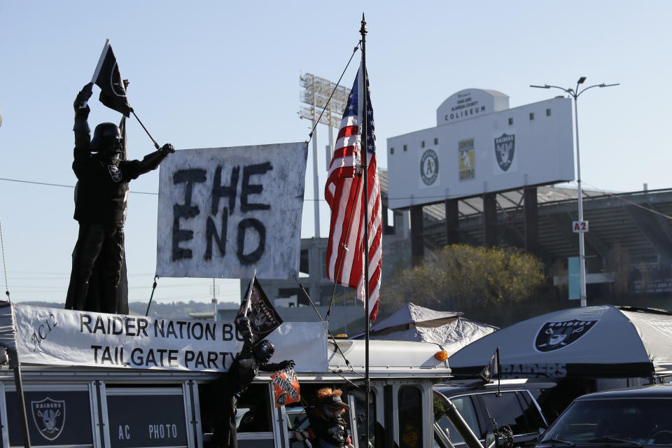 A sign reads "The End" on top of the Raider Nation Bus before the start of an NFL football between the Oakland Raiders and the Jacksonville Jaguars game in Oakland, Calif., Sunday, Dec. 15, 2019. The game is the final scheduled Raiders game in Oakland. (AP Photo/Eric Risberg)