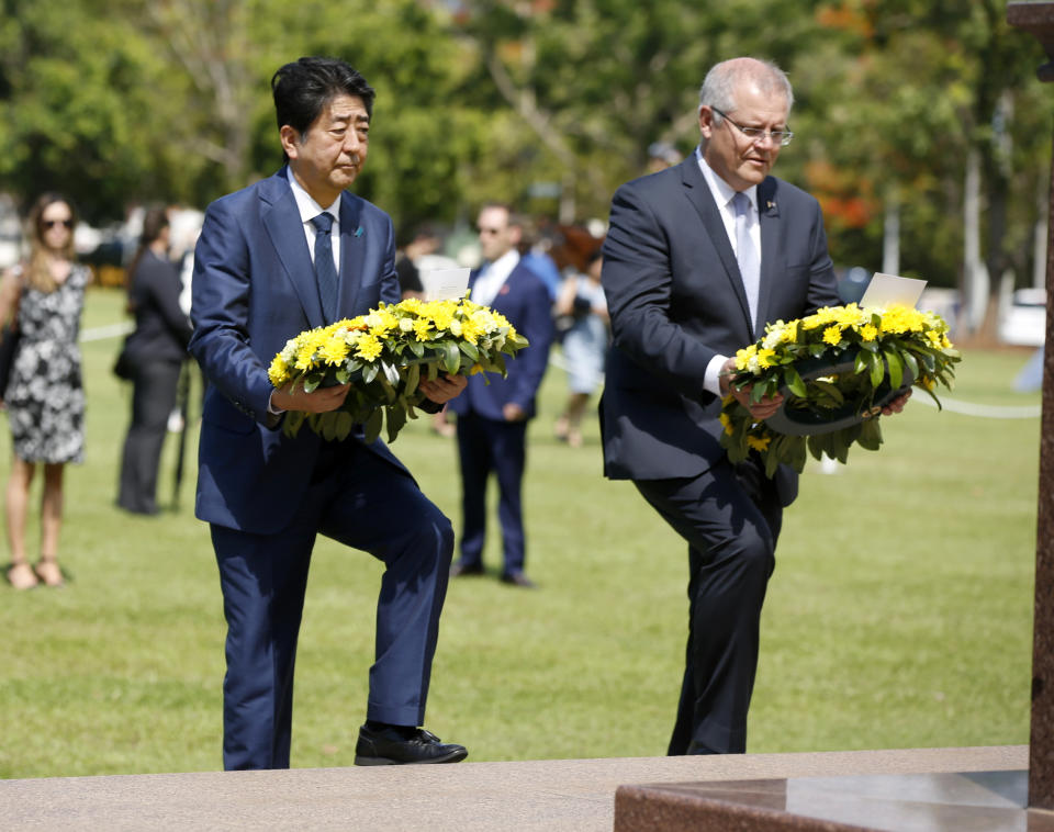 Japanese Prime Minister Shinzo Abe, left, lays a wreath along with Australian Prime Minister Scott Morrison at the Cenotaph War Memorial in Darwin, Australia, Friday, Nov. 16, 2018. (Glenn Campbell/Pool Photo via AP)