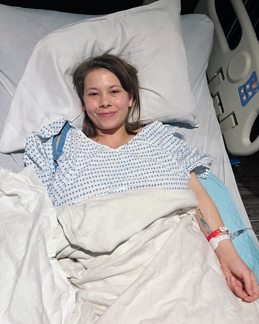 Bindi Irwin lying in a hospital bed